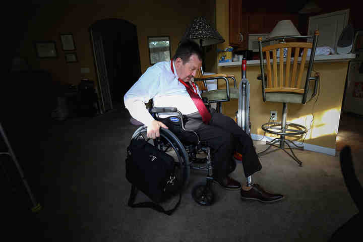 Hamilton County Commissioner Todd Portune gets ready for the day, Friday, Aug. 31, 2018, at his home in Green Township, Ohio. "I don't think of myself as disabled, so I'm certainly not going to become disabled," Portune said. "I don't have in-home healthcare or anything like that, and I could probably get it if I asked for it, but I don't want to ask for things I don't need."   (Kareem Elgazzar / The Cincinnati Enquirer)